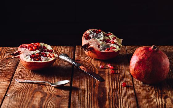 A Freshly Opened Pomegranate Fruit with Vintage Knife and Spoon
