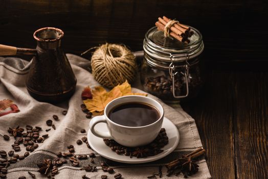 Cup of Coffee with Spices, Dried Autumn Leaves and Kitchen Equipment