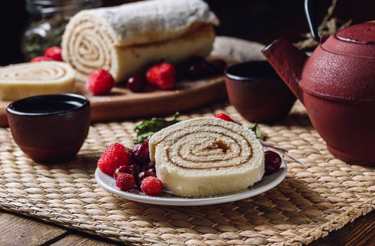 Biscuit Roll with Berries and Two Cup of Tea.