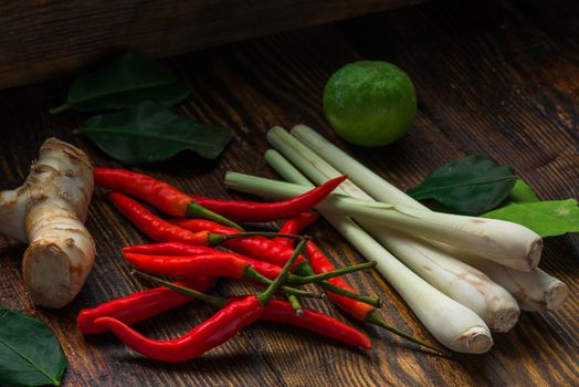 Mini chili peppers, galangal root, kaffir lime with leaves and lemongrass. Ingredients of Thai cuisine.