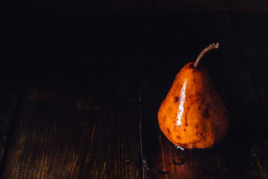 Golden Pear with Drops on Surface on Table