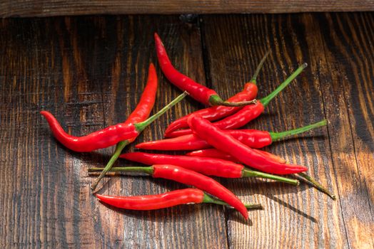 Pile of thai Bird's Eye Chilis on a old wooden table. Very hot seasoning