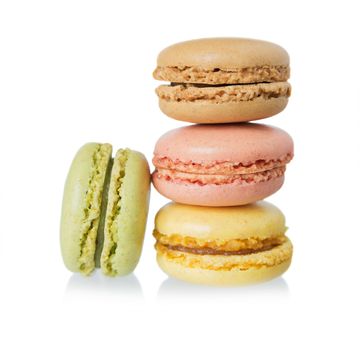 stack of several multicolored macaroons pastel colors isolated on white background