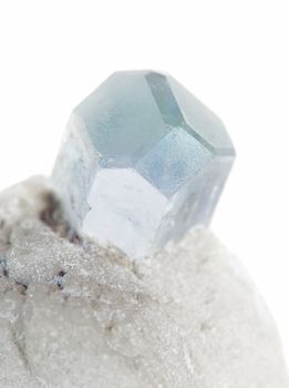 Beautiful crystal of blue aquamarine gemstone in an albite matrix close-up isolated on a white background