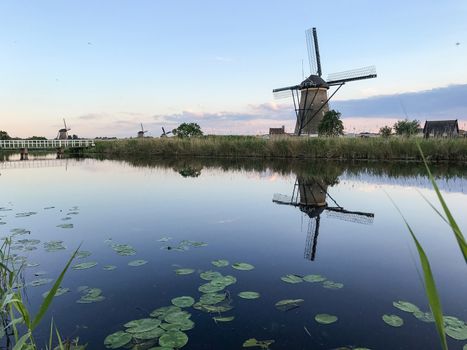 Beautiful dutch windmill landscape at the famous Kinderdijk canals, UNESCO world heritage site