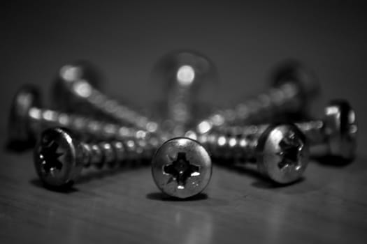 Black and white screws arranged in a circle