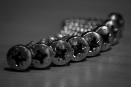 Macro of arranged screws in black and white