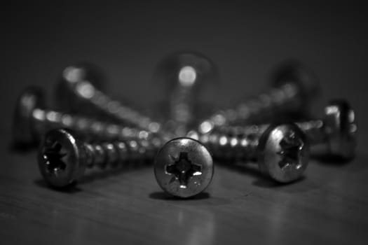 Black and white screws arranged in a circle