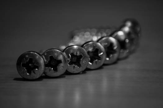 Macro of arranged screws in black and white