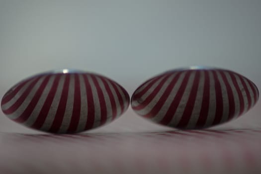 Two spoons composed to reflect red vertical lines