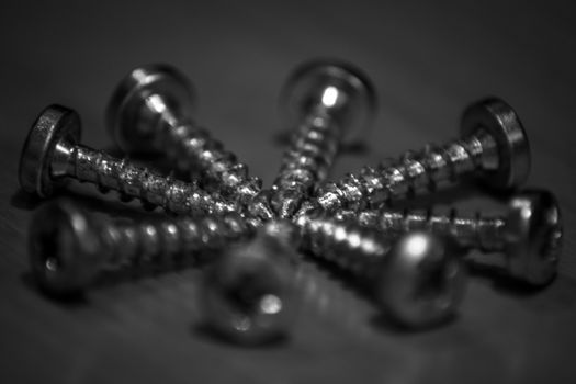Black and white screws arranged in a circle