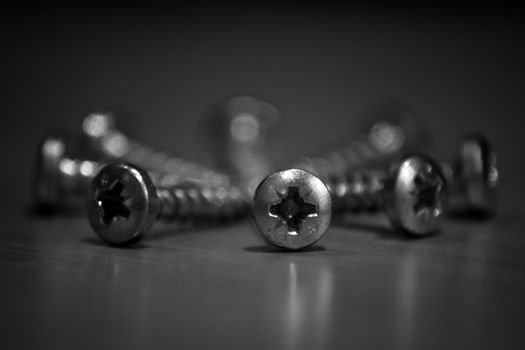 Black and white screws arranged in a circle
