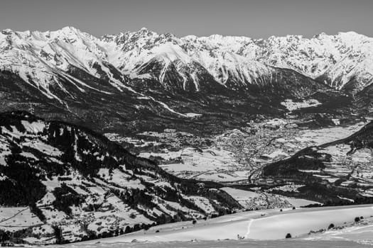 A village surrounded by mountains during winter