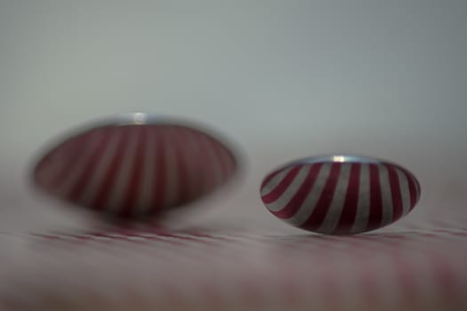 Two spoons composed to reflect red vertical lines