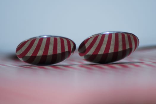 Two spoons composed to reflect red vertical lines