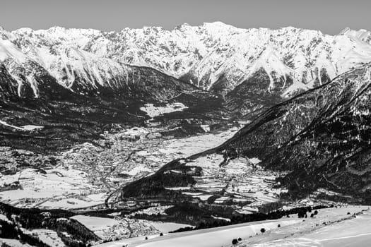 A village surrounded by mountains during winter