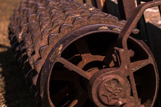 Closeup of a rusty old roller farm equipment