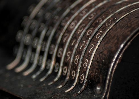 Closeup of an old vintage cash register with lots of numbers