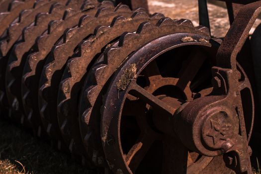 Closeup of a rusty old roller farm equipment