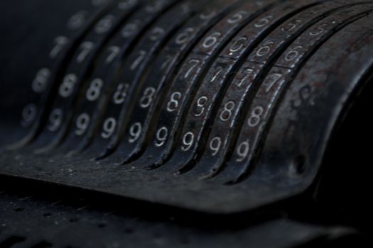 Closeup of an old vintage cash register with lots of numbers