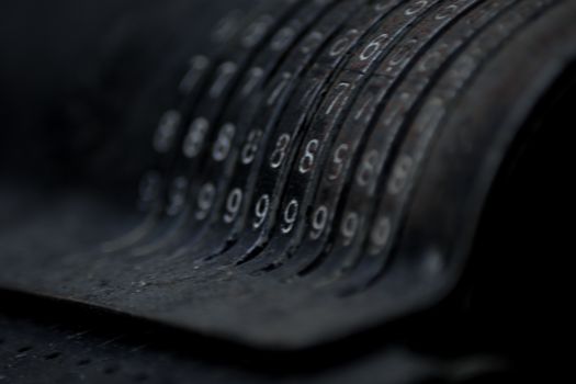 Closeup of an old vintage cash register with lots of numbers