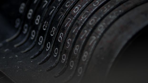 Closeup of an old vintage cash register with lots of numbers