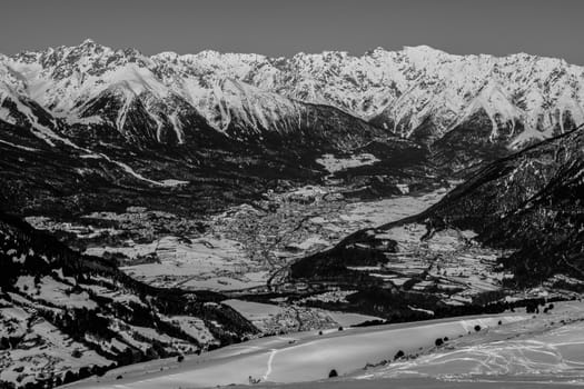 A village surrounded by mountains during winter