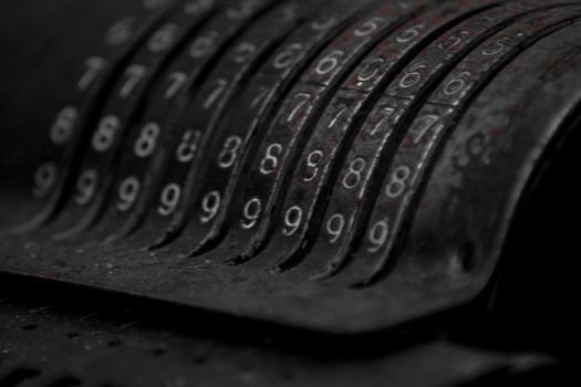 Closeup of an old vintage cash register with lots of numbers