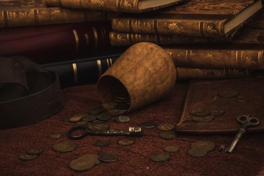 Antique still life composition with coins and books