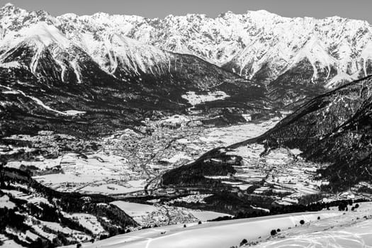 A village surrounded by mountains during winter