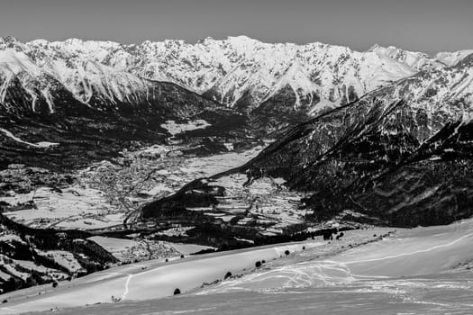 A village surrounded by mountains during winter