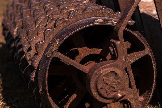 Closeup of a rusty old roller farm equipment