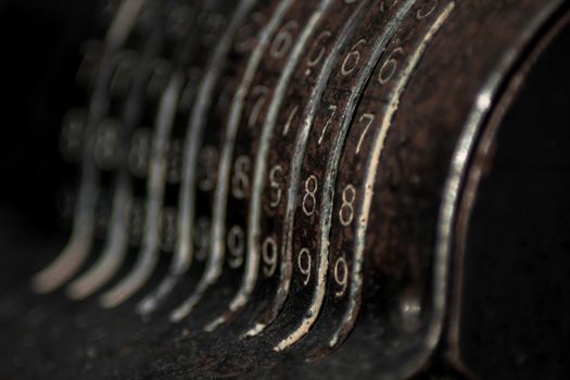 Closeup of an old vintage cash register with lots of numbers