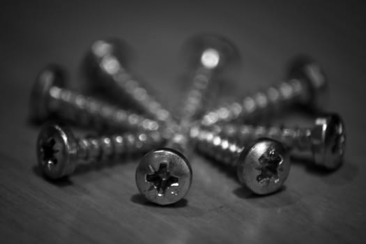 Black and white screws arranged in a circle