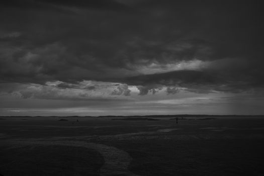 Stormy powerful clouds by the ocean during sunset