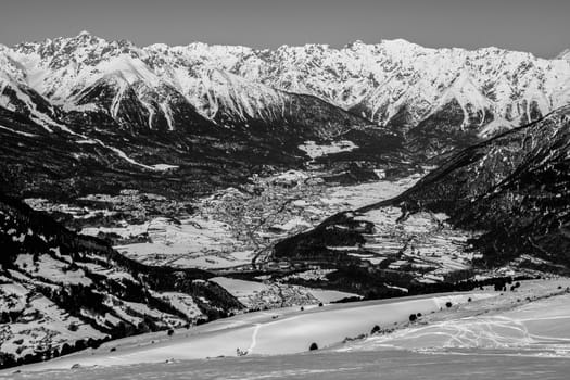 A village surrounded by mountains during winter