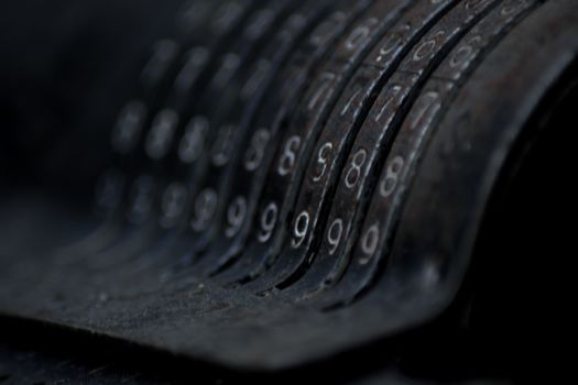 Closeup of an old vintage cash register with lots of numbers