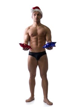 Christmas season: muscular bodybuilder shirtless wearing Santa Claus red hat, isolated on white