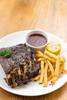 Grilled Barbecued Pork Baby Back Ribs with grilled sweet corn and fries