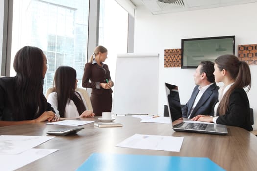 Business presntation on meeting of diverse people around the table