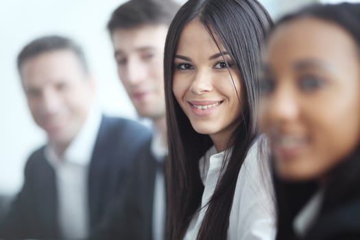 Business people sitting in a row and working, focus on pretty woman