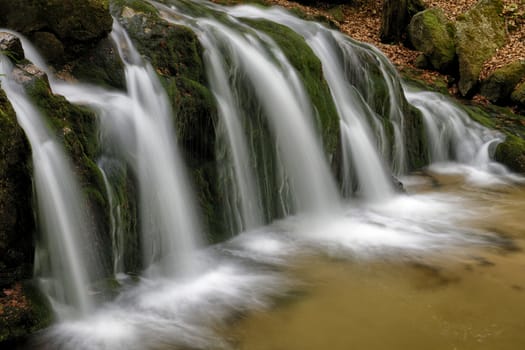 Beautiful Maly waterfall in super green spring forest surroundings, Czech Republic