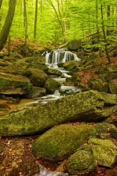 Beautiful Maly waterfall in super green spring forest surroundings, Czech Republic