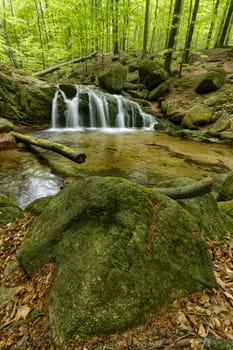 Beautiful Maly waterfall in super green spring forest surroundings, Czech Republic