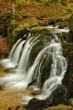 Beautiful Maly waterfall in super green spring forest surroundings, Czech Republic