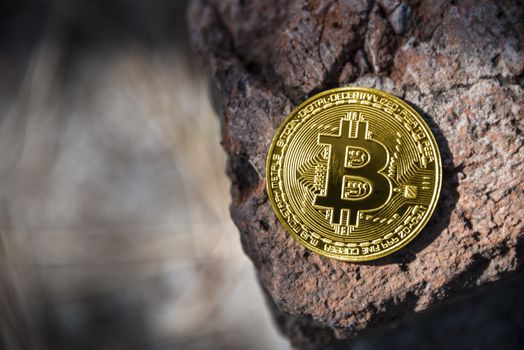 Gold coin Bitcoin on the stone background.