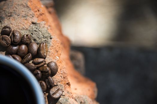 Cup of coffee and coffee beans on a stone background.