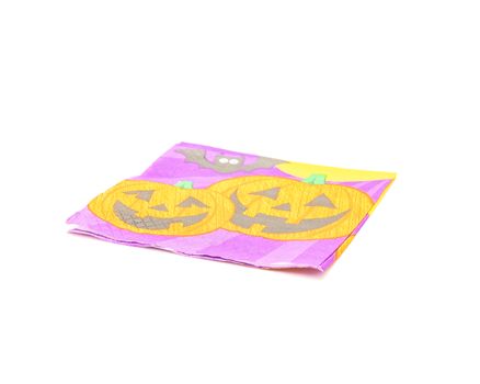 Single friendly Halloween napkin isolated on white background. Festive party tissue display pumpkins, bats, jack-o-lantern