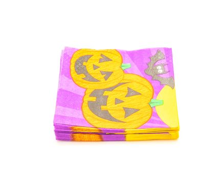 Top view stack of friendly Halloween napkins isolated on white background. Festive party tissue piles display pumpkins, bats, jack-o-lantern