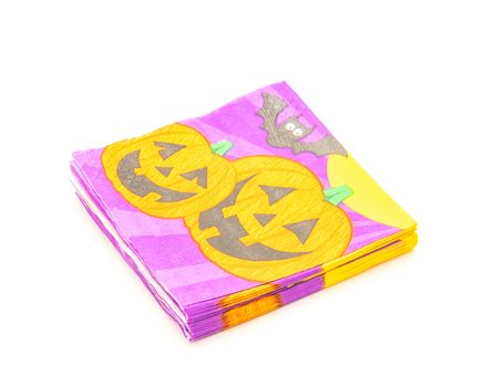 Top view stack of friendly Halloween napkins isolated on white background. Festive party tissue piles display pumpkins, bats, jack-o-lantern